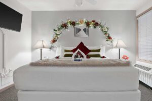 Platinum suite master bedroom with king bed at The Mill Creek Hotel and Suites in Lake Geneva