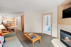 Platinum suite living area with TV, fire place, kitchen and sleeper sofa at The Mill Creek Hotel and Suites in Lake Geneva