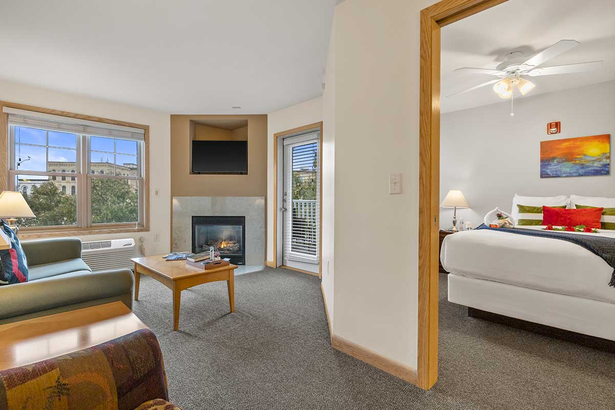 Living area and bedroom of Silver Plus Suite at The Mill Creek Hotel in Lake Geneva