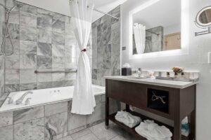 The Mill Creek Hotel Suites in Lake Geneva bathroom shower, soaking tub and vanity