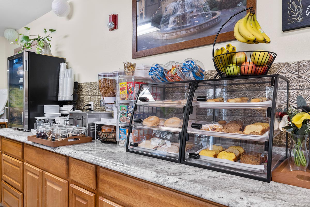 Bagels, bread and pastries alongside fresh fruit as part of the free hot and cold breakfast at The Mill Creek Hotel and Suites in Lake Geneva Wisconsin